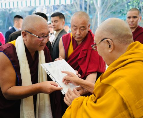 Offering 13 Tibetan translated books to His Holiness the Dalai Lama